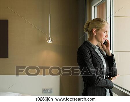 Picture - A businesswoman using a cell phone. Fotosearch