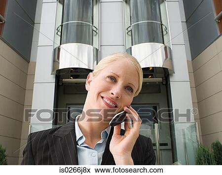 A businesswoman using a cell phone View Large Photo Image Stock Photo - A businesswoman using a cell phone. Fotosearch