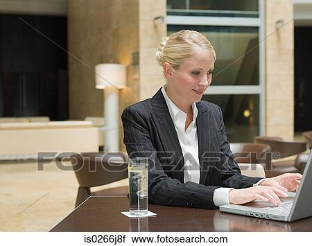 Stock Image - A businesswoman using a laptop. Fotosearch