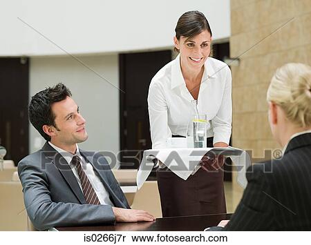 A waitress serving business people View Large Photo Image Stock Photography - A waitress serving business people. Fotosearch