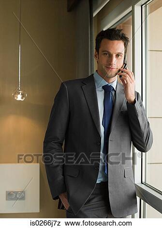 Stock Photo - Portrait of a businessman using a cell phone. Fotosearch