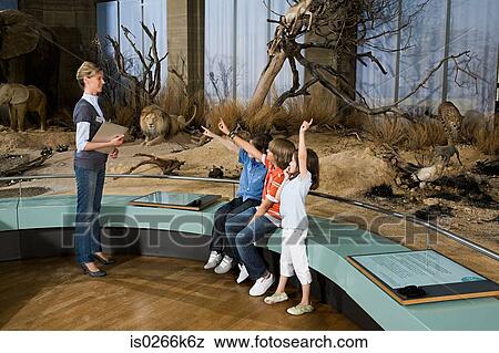 Children and a teacher at a museum View Large Photo Image Stock Photo - Children and a teacher at a museum. Fotosearch