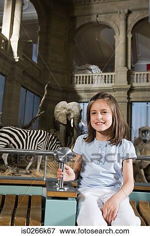 Girl sitting in a museum View Large Photo Image Stock Photo - Girl sitting in a museum. Fotosearch