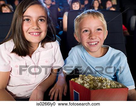 A boy and girl watching a movie View Large Photo Image Stock Image - A boy and girl watching a movie. Fotosearch
