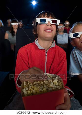 Stock Image - A boy watching a 3d movie. Fotosearch