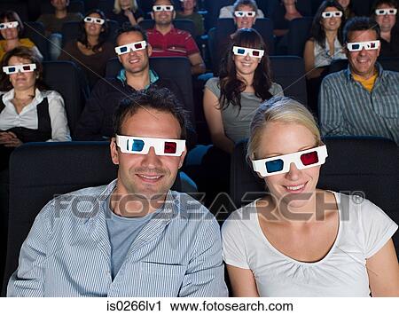 Stock Image - A couple watching a 3d movie. Fotosearch