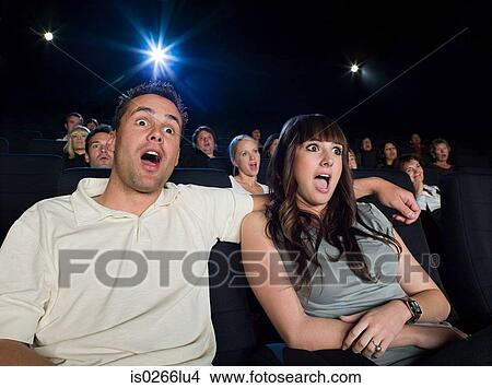 A couple watching a movie View Large Photo Image Picture - A couple watching a movie. Fotosearch