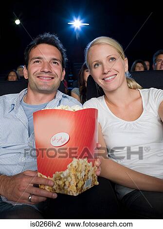 Stock Image - A couple watching a movie. Fotosearch