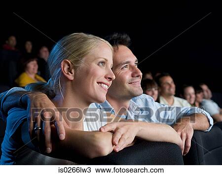 Stock Image - A couple watching a movie. Fotosearch