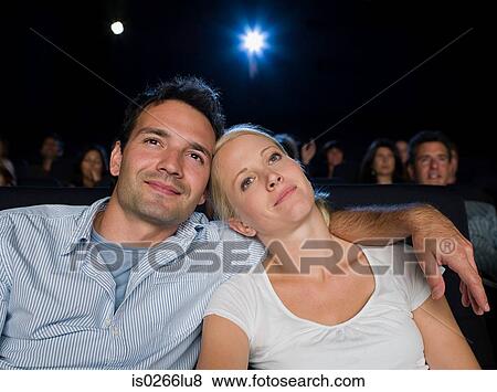 A couple watching a movie View Large Photo Image Stock Photo - A couple watching a movie. Fotosearch