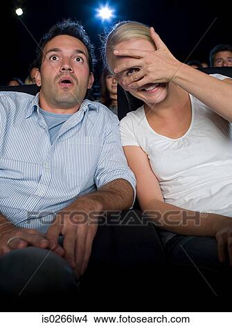 A couple watching a scary movie View Large Photo Image Picture - A couple watching a scary movie. Fotosearch