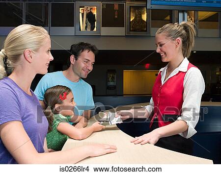 A family buying tickets from the box office View Large Photo Image Picture - A family buying tickets from the box office. Fotosearch