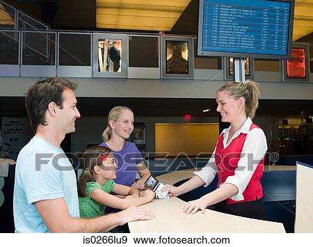 Stock Photo - A family buying tickets from the box office. Fotosearch