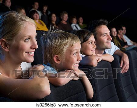 A family watching a movie View Large Photo Image Stock Photo - A family watching a movie. Fotosearch