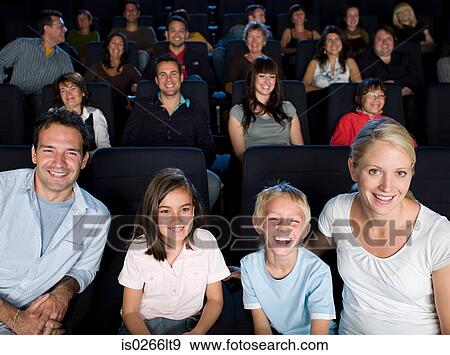 A family watching a movie View Large Photo Image Stock Photo - A family watching a movie. Fotosearch