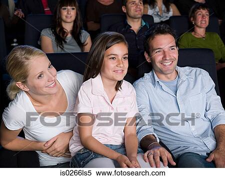 Stock Photography - A family watching a movie. Fotosearch