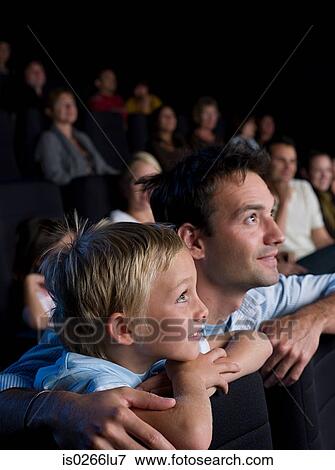 A father and son watching a movie View Large Photo Image Stock Photo - A father and son watching a movie. Fotosearch