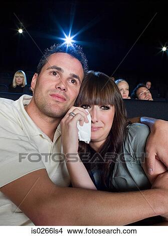 A man comforting a woman watching a sad movie View Large Photo Image Picture - A man comforting a woman watching a sad movie. Fotosearch