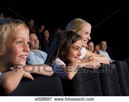 A mother and her children watching a movie View Large Photo Image Stock Photo - A mother and her children watching a movie. Fotosearch