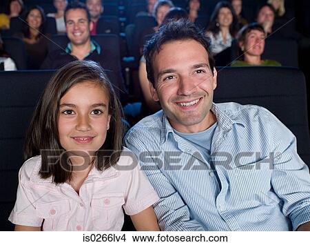 Father and daughter watching a movie View Large Photo Image Picture - Father and daughter watching a movie. Fotosearch