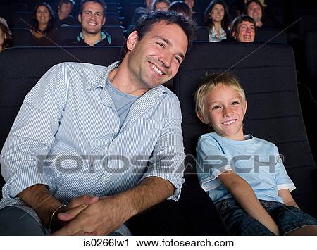 Father and son watching a movie View Large Photo Image Stock Image - Father and son watching a movie. Fotosearch