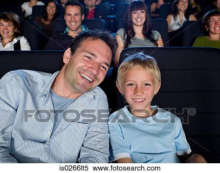 Father and son watching a movie View Large Photo Image Stock Photography - Father and son watching a movie. Fotosearch