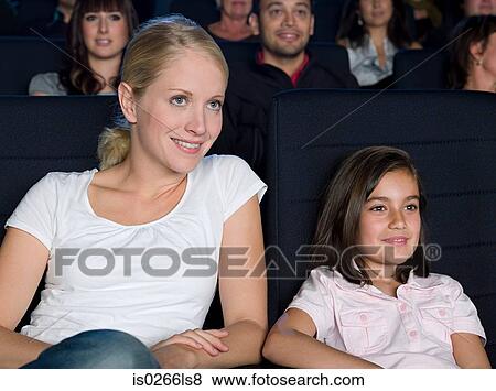 Mother and daughter watching a movie View Large Photo Image Stock Photo - Mother and daughter watching a movie. Fotosearch