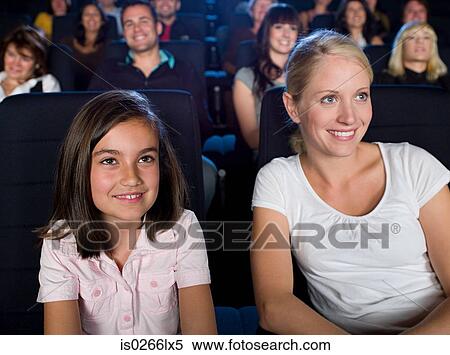 Mother and daughter watching a movie View Large Photo Image Stock Photography - Mother and daughter watching a movie. Fotosearch