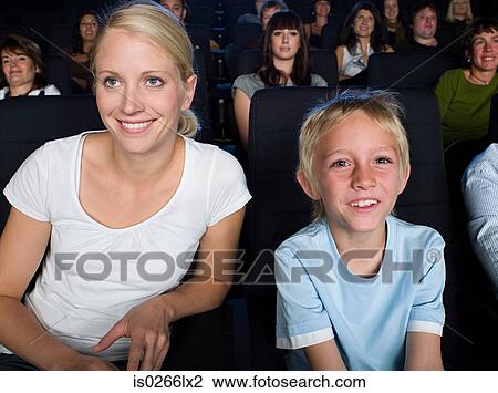 Stock Image - Mother and son watching a movie. Fotosearch