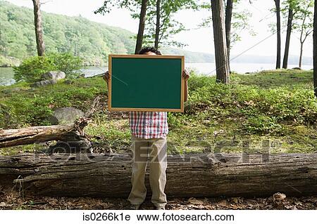 A boy holding a blackboard View Large Photo Image Stock Image - A boy holding a blackboard. Fotosearch