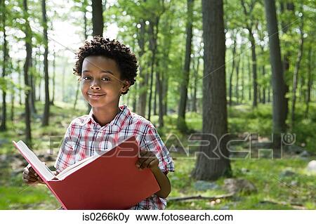 A boy holding a book View Large Photo Image Stock Photo - A boy holding a book. Fotosearch