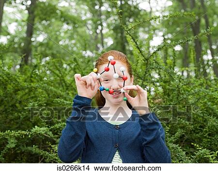 A girl holding a dna model View Large Photo Image Picture - A girl holding a dna model. Fotosearch
