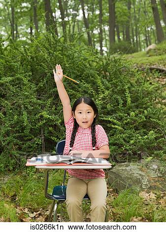 Picture - A girl with her arm raised. Fotosearch