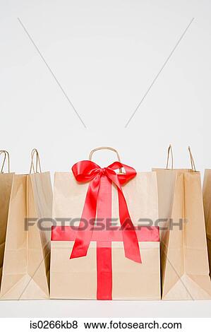 Bow and ribbon on a paper bag View Large Photo Image Stock Photo - Bow and ribbon on a paper bag. Fotosearch