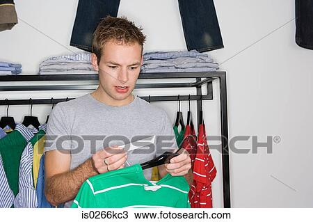 Man looking at an expensive price tag View Large Photo Image Stock Image - Man looking at an expensive price tag. Fotosearch