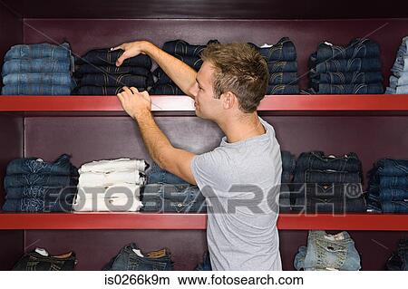 Man shopping for a pair of jeans View Large Photo Image Picture - Man shopping for a pair of jeans. Fotosearch