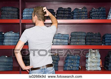 Man shopping for jeans View Large Photo Image Stock Image - Man shopping for jeans. Fotosearch
