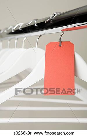 Red label on a clothes hanger View Large Photo Image Stock Photography - Red label on a clothes hanger. Fotosearch