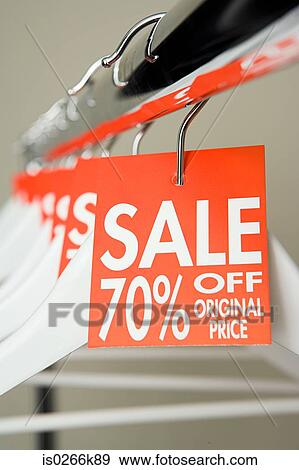 Stock Photo - Sale labels on clothes hangers. Fotosearch