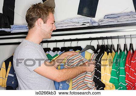 Smiling man clothes shopping View Large Photo Image Stock Image - Smiling man clothes shopping. Fotosearch