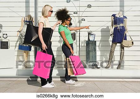 Two women window shopping View Large Photo Image Stock Image - Two women window shopping. Fotosearch