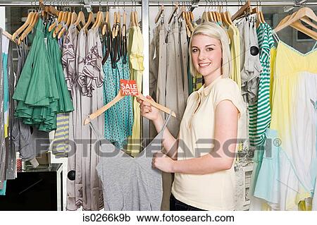 Stock Image - Woman at a clothes sale. Fotosearch