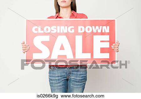 Woman holding a closing down sign View Large Photo Image Stock Image - Woman holding a closing down sign. Fotosearch
