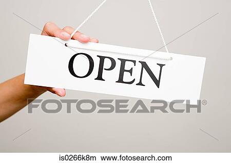 Woman holding an open sign View Large Photo Image Picture - Woman holding an open sign. Fotosearch