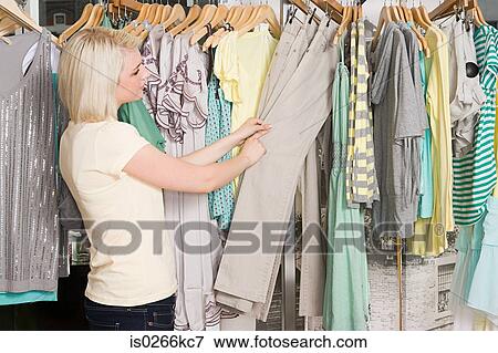 Woman shopping for clothes View Large Photo Image Stock Photo - Woman shopping for clothes. Fotosearch