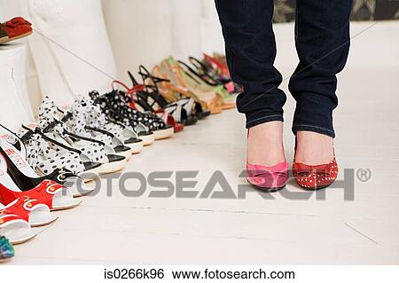 Stock Photograph - Woman shopping for shoes. Fotosearch