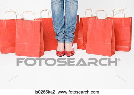 Woman standing with shopping bags View Large Photo Image Stock Image - Woman standing with shopping bags. Fotosearch