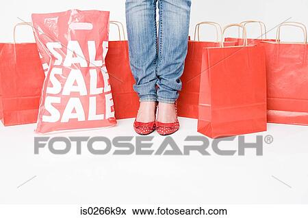 Woman standing with shopping bags View Large Photo Image Stock Photo - Woman standing with shopping bags. Fotosearch