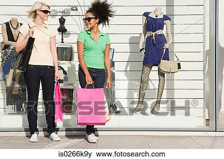 Womes standing outside a clothes store View Large Photo Image Stock Photo - Womes standing outside a clothes store. Fotosearch