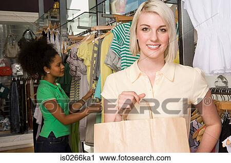 Young women in a clothes store View Large Photo Image Stock Image - Young women in a clothes store. Fotosearch